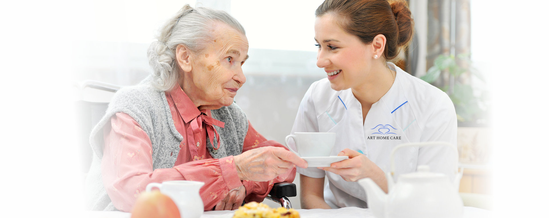 nurse serving soup to an elderly woman